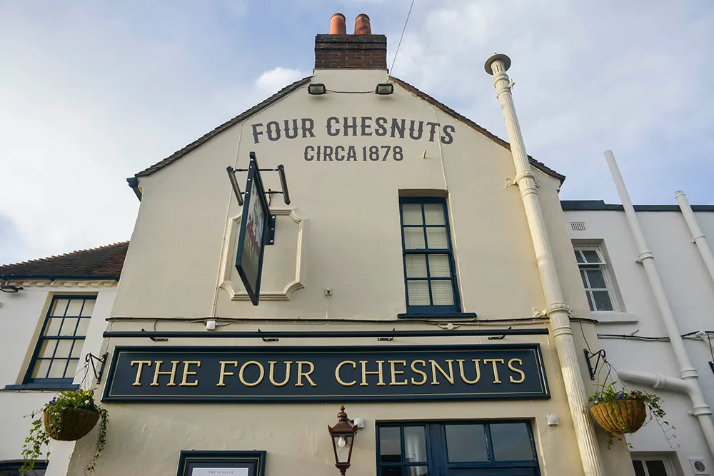 The Four Chesnuts gable end, painted with Four Chesnuts circa 1878 above the pub sign